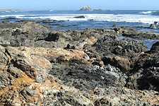 A colorful jumble of various kinds of rocks, known as a melange, includes pillow lavas.