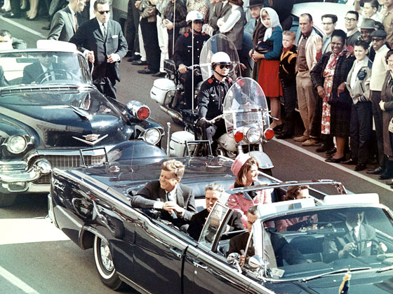 President John F. Kennedy in the limousine in Dallas, Texas, on Main Street, minutes before the assassination.