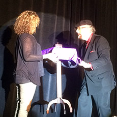 Magician Jamy Ian Swiss explains to skeptics how easy it is to be fooled, and then fooled them by levitating a table, with the assistance of Tina Shermer, sister of the Skeptics Society director Michael Shermer.