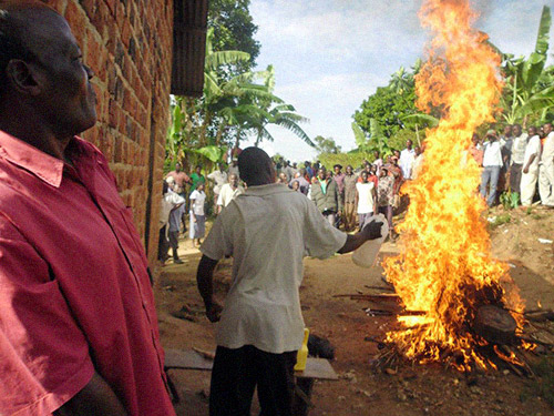 As about 200 people watch, gasoline is poured on a bonfire and the alleged witchcraft items are burned to destroy the evil spirits.