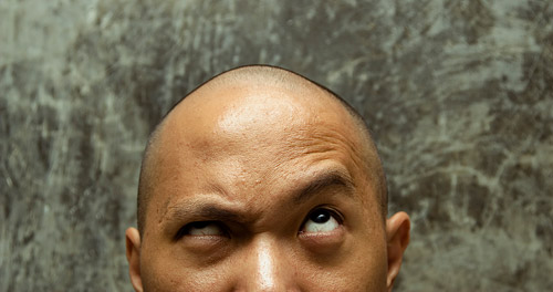 man with furrowed brown, looking up