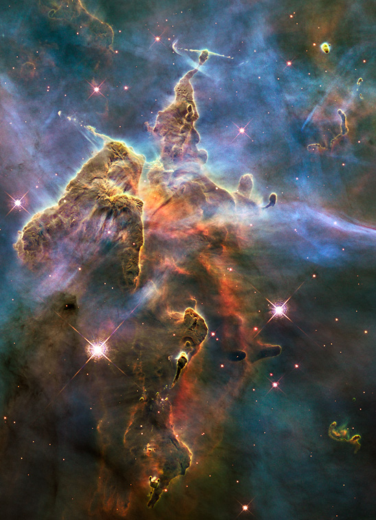 A a mountain of dust and gas rising in the Carina Nebula. Credit: NASA, ESA, and M. Livio and the Hubble 20th Anniversary Team (STScI)