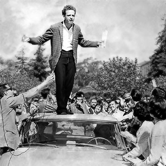 UC Berkeley, Sproul Hall Plaza, October 1 1964. Free Speech Movement advocates, including Mario Savio in this instance, speak from the roof of a police car.